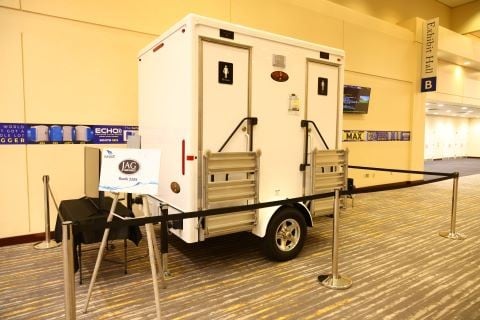 portable restroom trailer in indoor display in the walkway to the WWETT Expo Hall