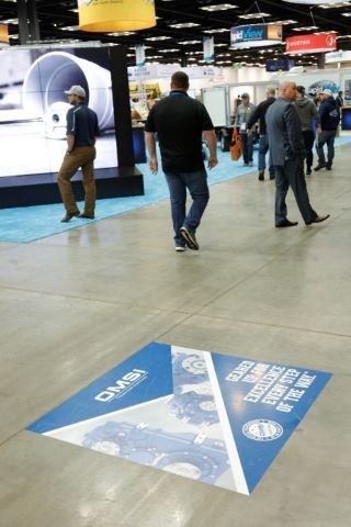 Floor cling ad on the floor of the WWETT Expo Hall walkway