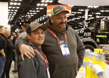 2 attendees posing for a photo on the expo hall floor