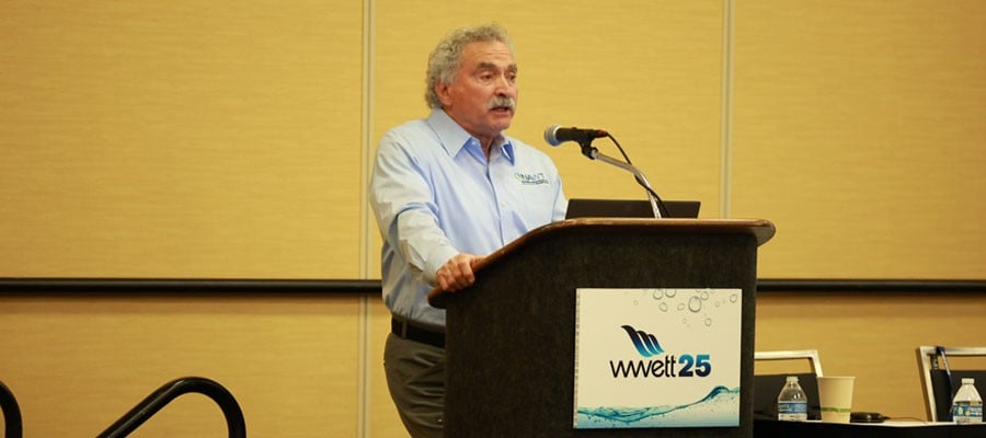 Male speaker at a podium on-stage at WWETT 2025